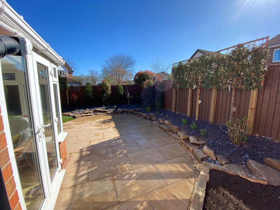 Decorative gravel area with curved retaining wall and brick edging