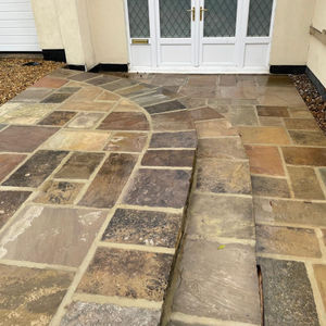 Close view of relaid York stone steps with rounded edges, highlighting craftsmanship and natural stone texture.