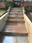 Stone steps leading to a house entrance, professional landscaping design. Wilkinsons Landscapes