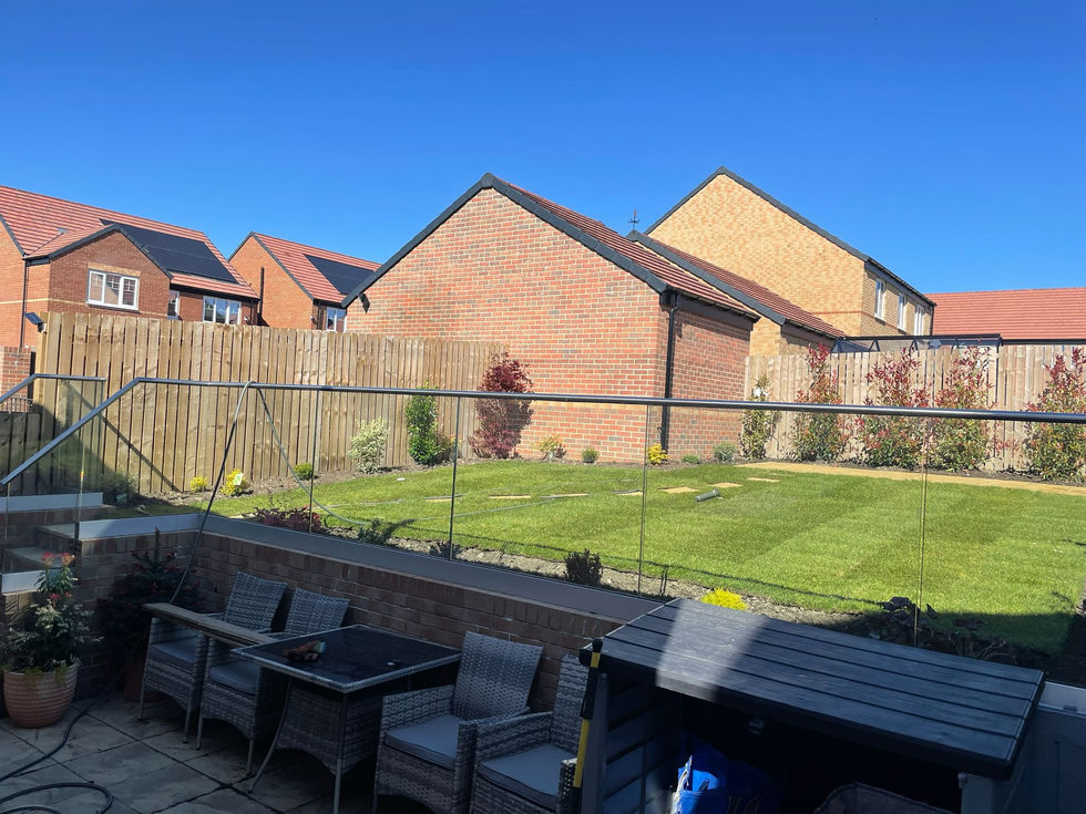Contemporary family garden with structured borders, fresh turf and modern fencing.