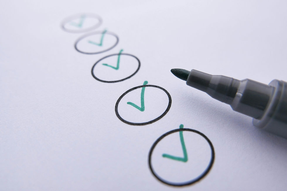 Green checkmarks in black circles on white paper, marked by a dark green pen, convey a sense of completion and organization.