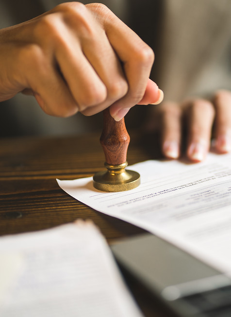closeup-person-stamping-documents-approve-agreements.jpg