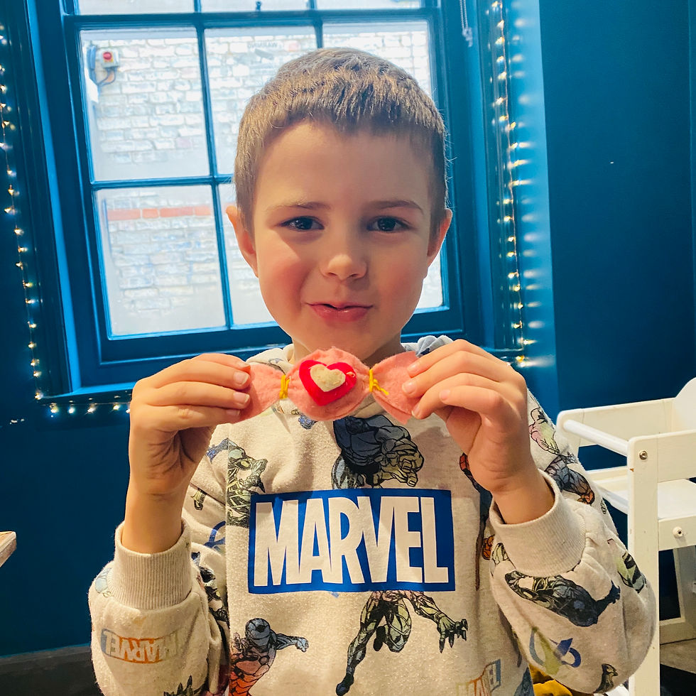 Child holds up a felt sweet
