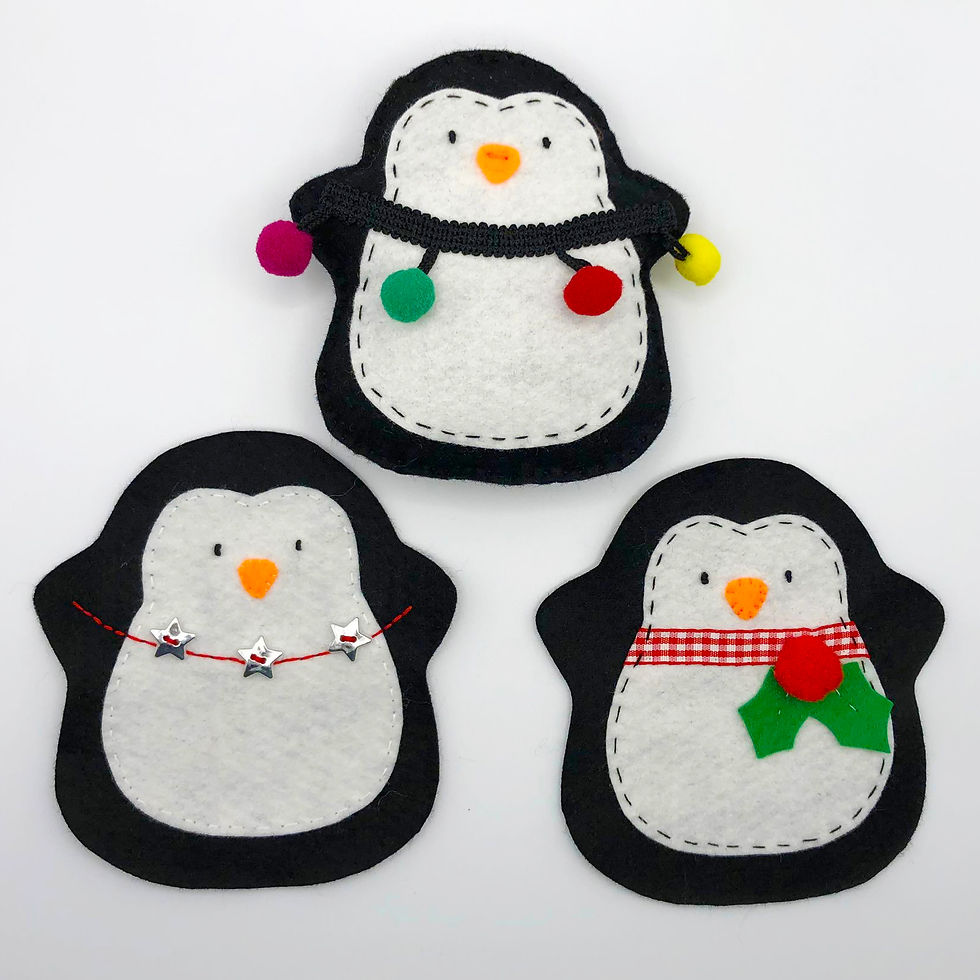 Three felt penguins