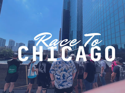 A crowd stands on a bridge observing the chicago skyline. The title "Race to Chicago" is emblazoned across.