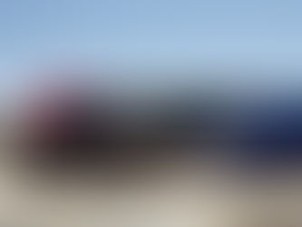 An Amtrak train engine with red and blue swooping color blocks aross it's side and a white amtrak logo.