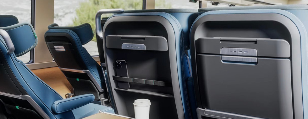 Amtrak's long distance fleet proposal rendering of passenger seating with large recline, phone holders, and tables - Amtrak