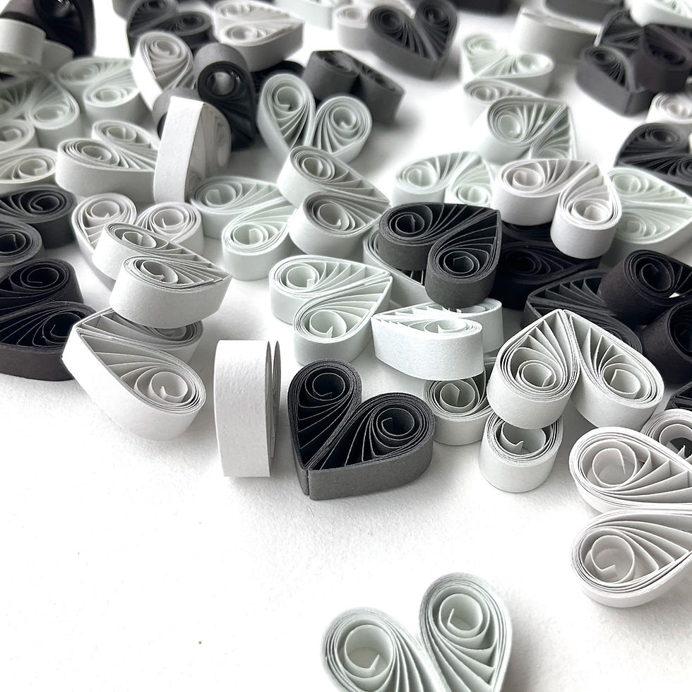 Little silvery gray, white, and black quilled paper heart ornaments for Valentine, Christmas, and New Year’s decor