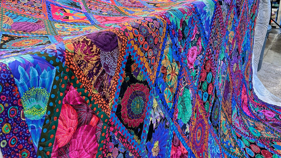 Quilt on a longarm machine with quilting just completed.