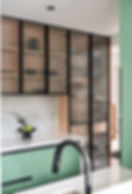 Pastel green aluminium kitchen with fluted glass shutters and premium modular design