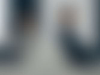 A couple sitting apart on a couch, showing signs of quiet quitting a relationship