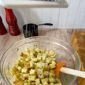 Sprinkling the croutons on salmon salad