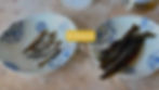 Two plates on a textured surface: one with dried fish (niboshi), the other with seaweed (kombu). Text overlay: Dashi, Niboshi & Kombu.