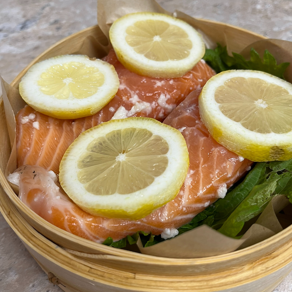 salt koji marinated salmon and cut lemons in a Seiro, the bamboo steamer
