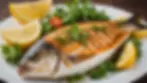 Close-up view of grilled fish garnished with herbs and lemon