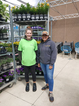 Two Simply Set Merchandisers in a group photo with a flower rack in the background