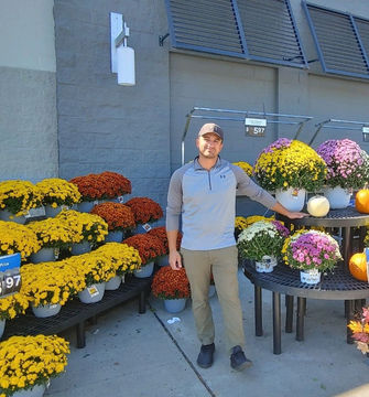 A Simply Set Merchandiser with their displayed flowers in the background