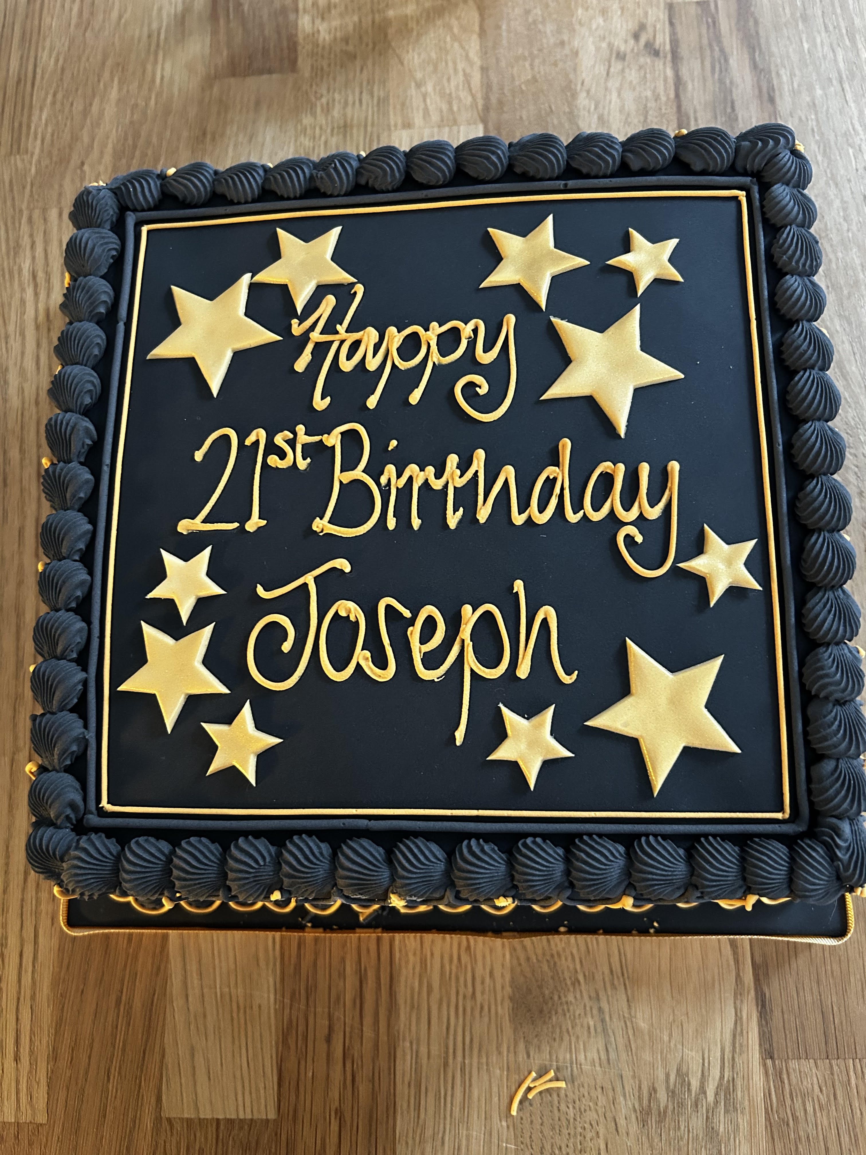 Bespoke cake with intricate floral icing and gold accents, perfect for celebration in Solihull, West Midlands.