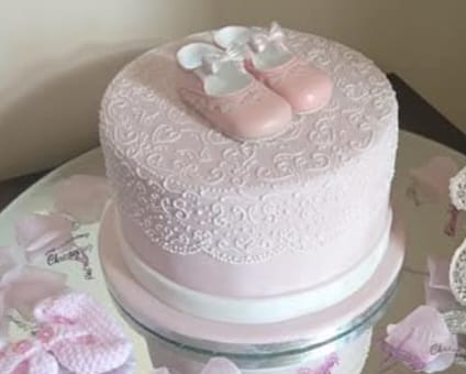 Bespoke cake with intricate floral designs and gold accents, perfect for celebration in Solihull, West Midlands.