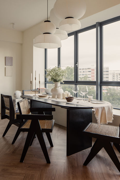 Clarice in Paris, a Parisian-inspired condominium renovation by Studio Metanoia, features a chic blend of minimalist design and vintage elegance. This 1130-sqft home showcases custom marble elements, a statement fireplace, herringbone flooring, and luxurious finishes, including a chandelier, black oak furnishings, and brass accents. The open-concept living space is bathed in natural light, while personal touches from the homeowners' travels add unique charm. A sophisticated Parisian powder room and master bedroom with French linen bedding complete the home's timeless yet contemporary aesthetic.