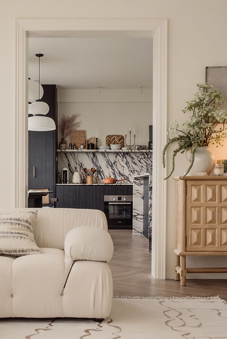 Clarice in Paris, a Parisian-inspired condominium renovation by Studio Metanoia, features a chic blend of minimalist design and vintage elegance. This 1130-sqft home showcases custom marble elements, a statement fireplace, herringbone flooring, and luxurious finishes, including a chandelier, black oak furnishings, and brass accents. The open-concept living space is bathed in natural light, while personal touches from the homeowners' travels add unique charm. A sophisticated Parisian powder room and master bedroom with French linen bedding complete the home's timeless yet contemporary aesthetic.