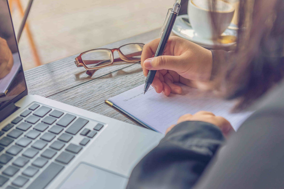 close-up-of-woman-writing-notebook-beside-laptop-2026-03-26-22-59-24-utc (1).jpg