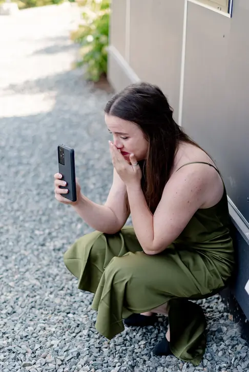 A summer wedding ceremony in American Creek Lodge Hope, British Columbia with the sister of bride filming bride and groom's vows.