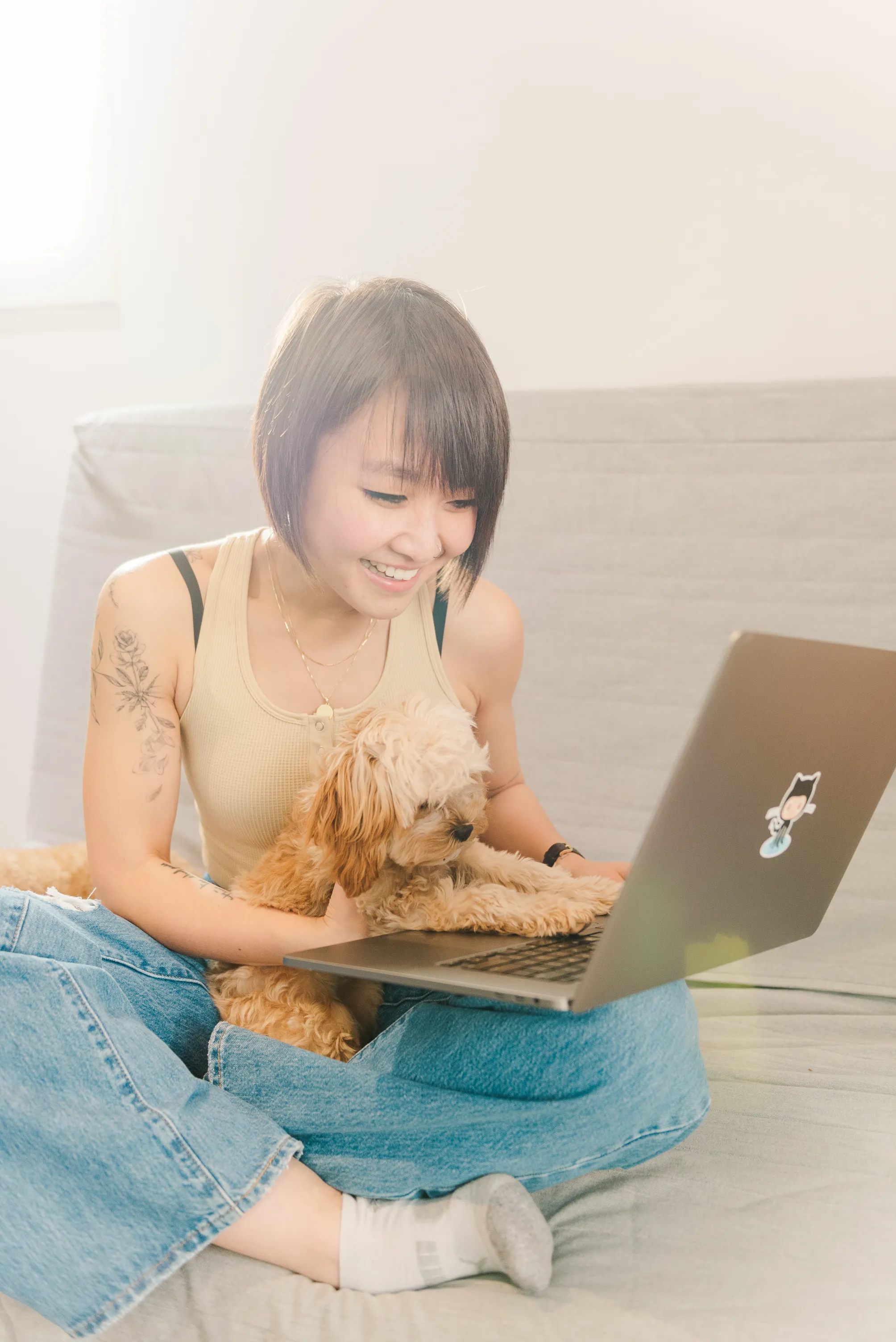 Anne with her dog on her lap and a laptop in Vancouver British Columbia