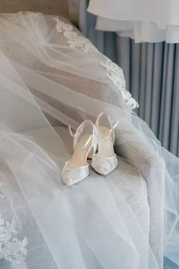 Bridal shoes laying on chair while bride gets ready for summer weading in At Westin Bayshore Vancouver, British Columbia