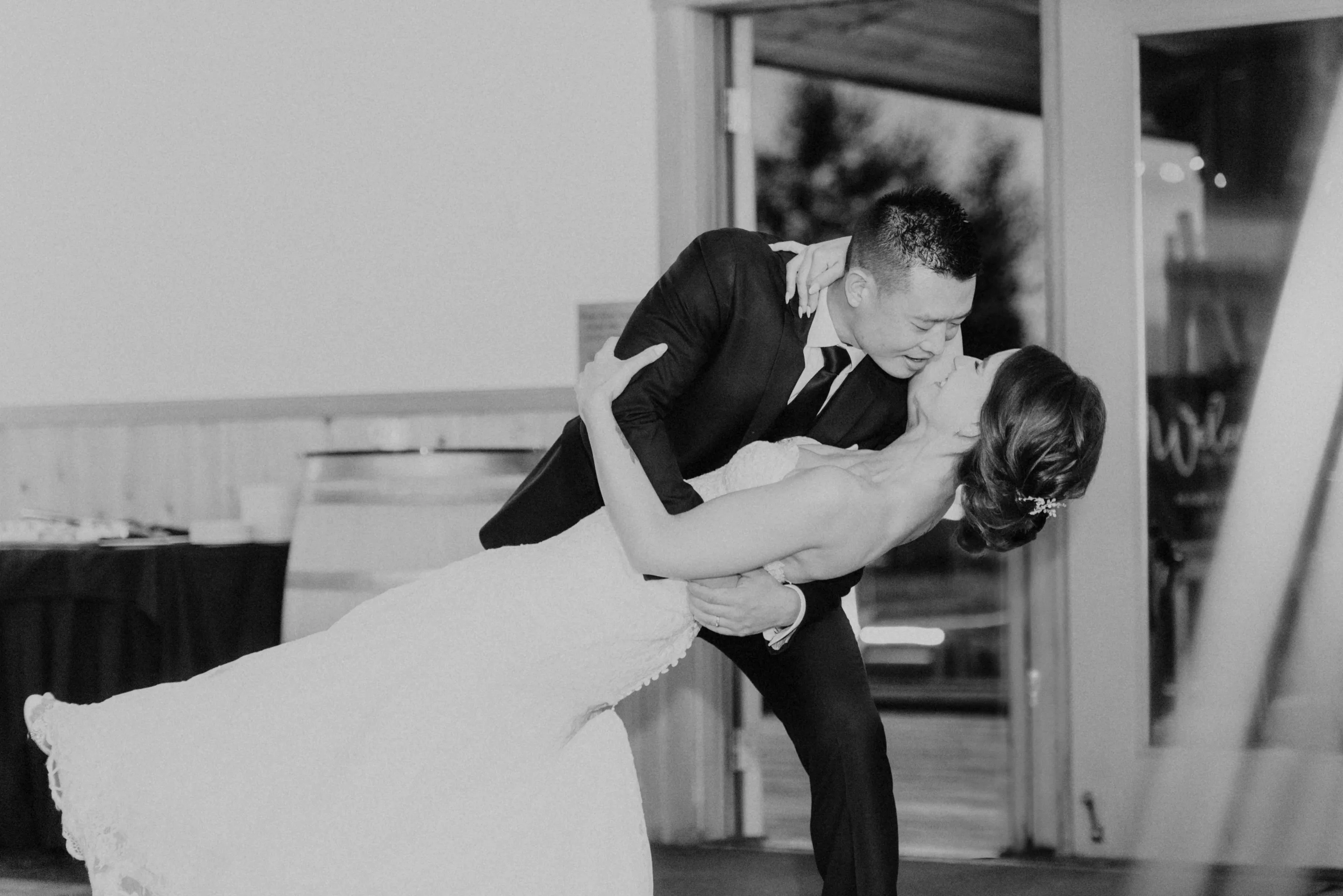 Black and White shot of groom holding bride at Fraser River Lodge, Agassiz, British Columbia