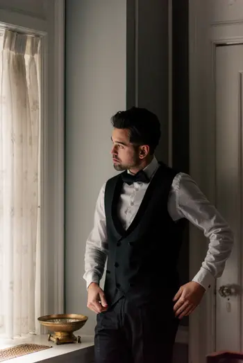 dark and moody shot of groom getting ready for summer wedding in Hycroft Manor, Vancouver, British Columbia