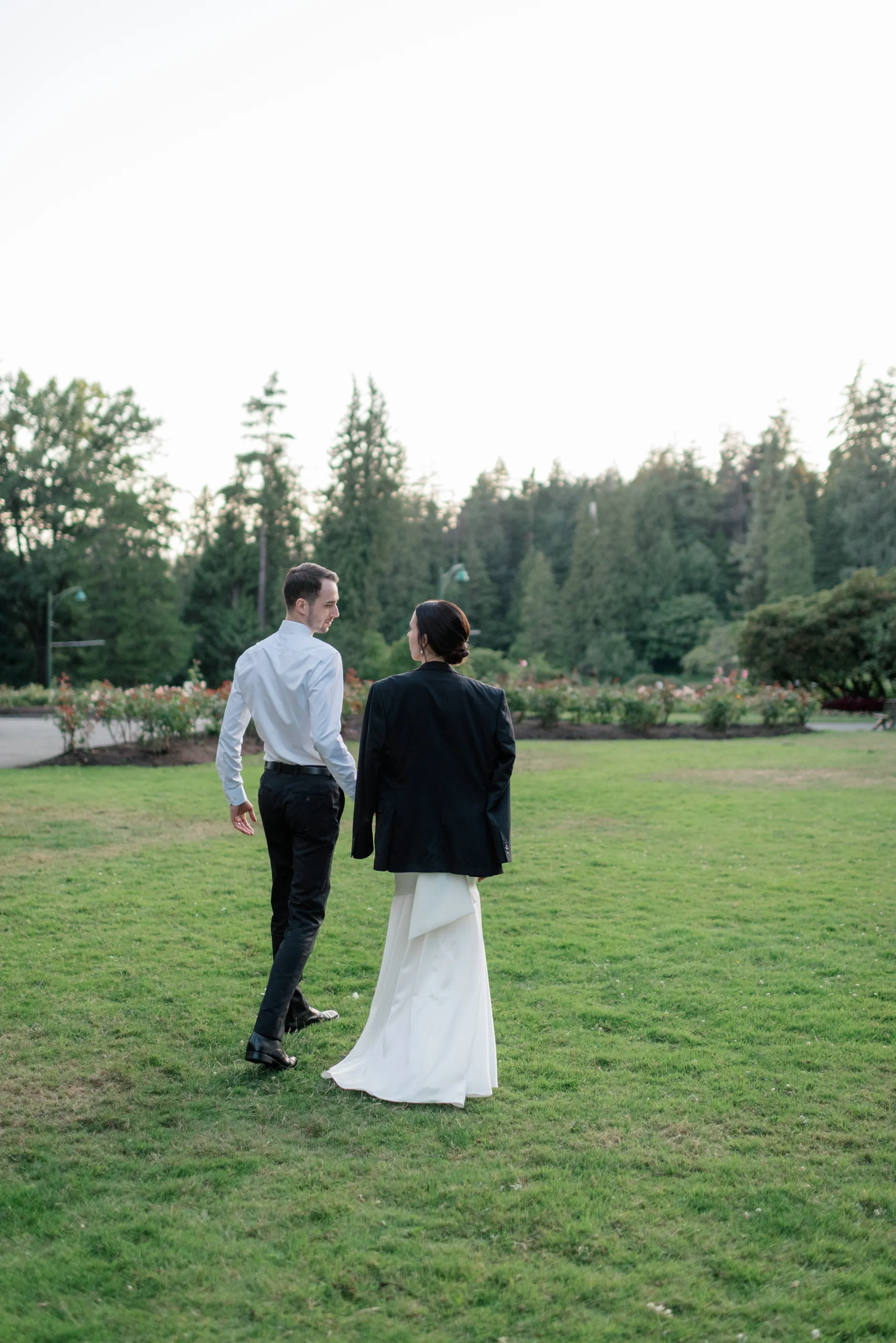 Bride and Groom walking during summer wedding in stanley park pavillion, Vancouver, British Columbia