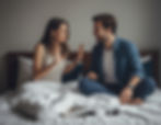 A couple feels discomfort from bad breath, hindering intimacy on an otherwise relaxed morning in bed.
