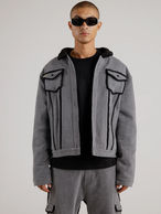 Photo of someone wearing a grey denim jacket