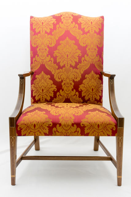 Lolling chair with red and gold upholstery