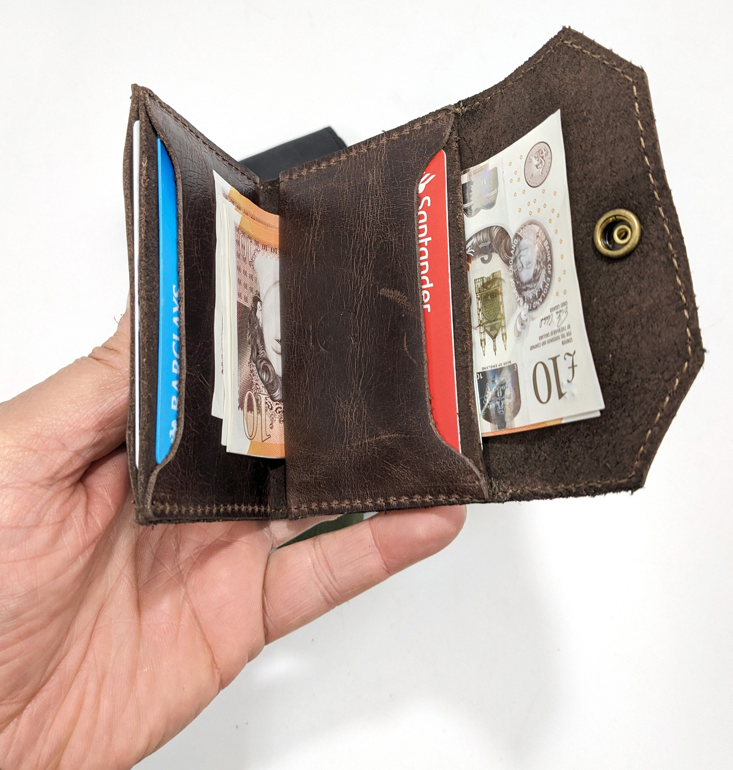 Open handmade minimalist bifold leather wallet with cards and cash
