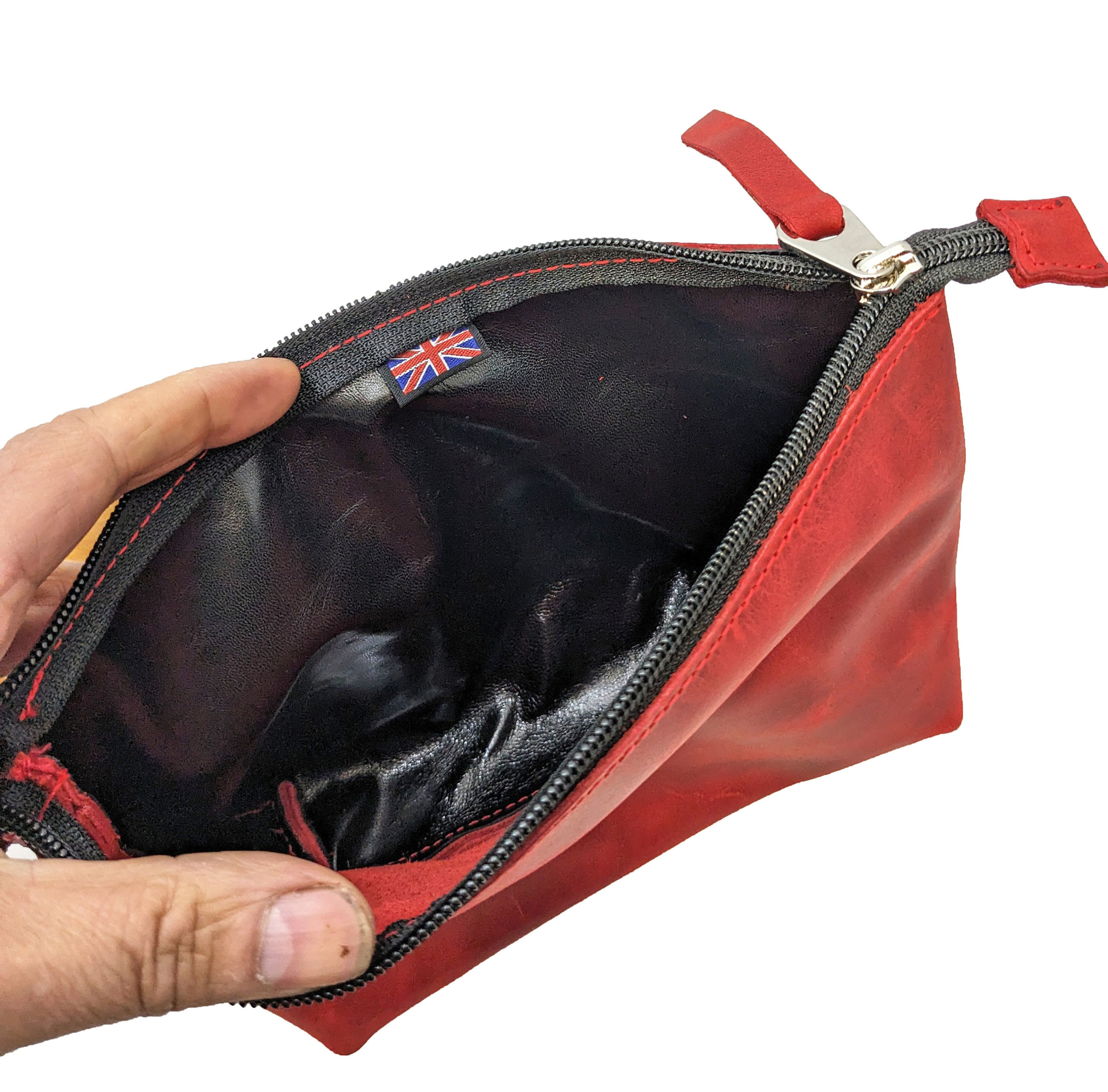 Open red leather utility pouch showing black lining