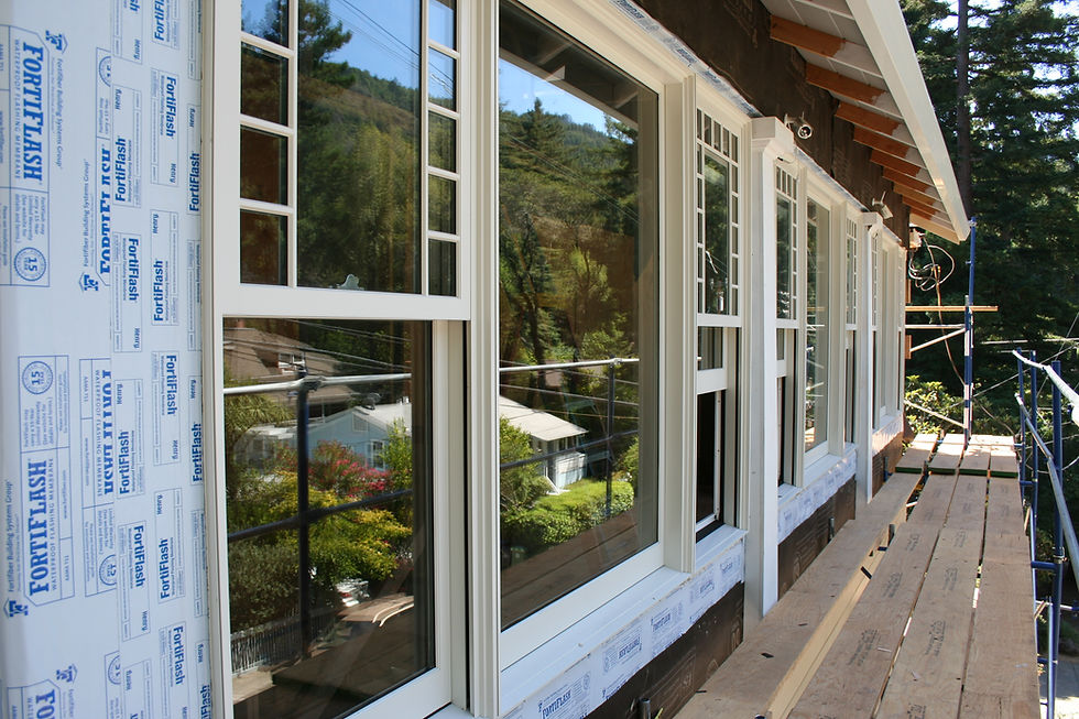 New upper level enclosed front porch multi-lite picture and double-hung windows.