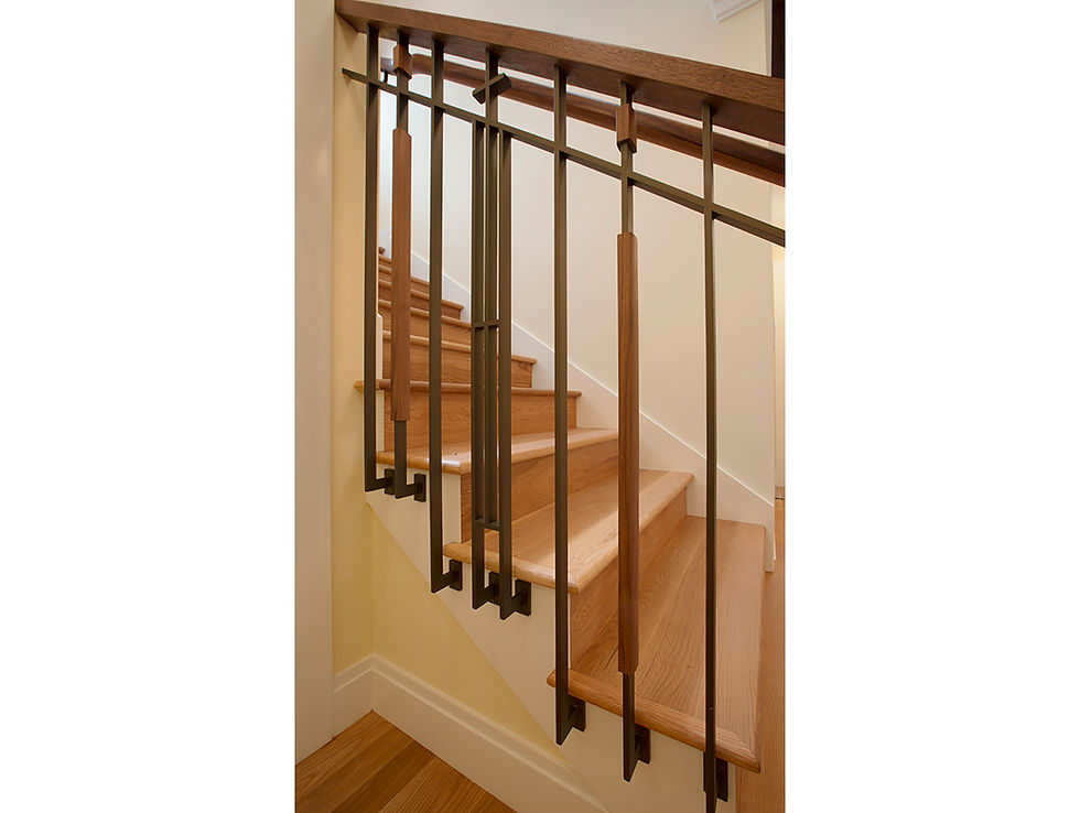 Custom Craftsman style steel and walnut balustrade and handrail at stairwell.