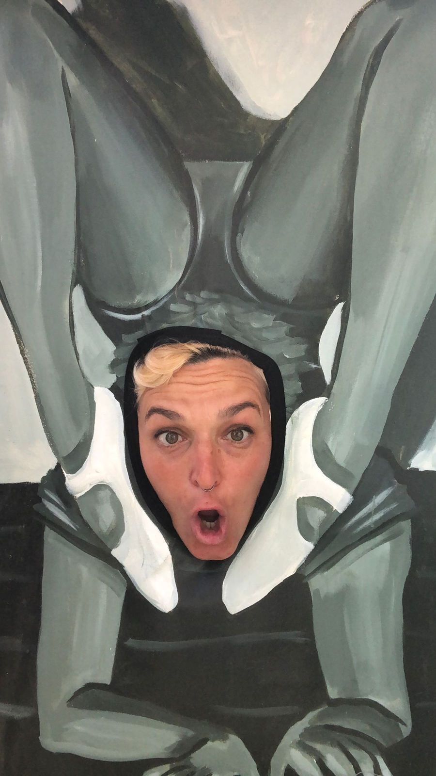 Woman puts her face in a filter of a woman doing an acrobatic pose in black and white