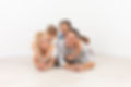 A happy family of four on floor.