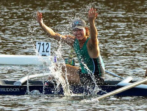 Rower celebrating in boat 712 with water splashing