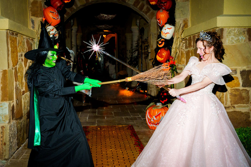 Witch vs. princess, Halloween, holding a magic wand and broom, festive decor.
