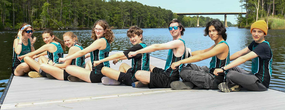Rowing team sitting linked on a dock