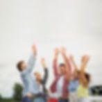 happy-friends-raising-their-hands-outdoors.jpg
