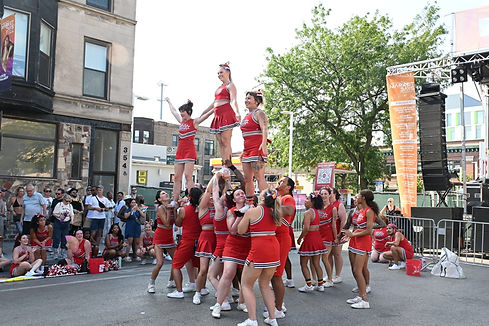 Cheerleaders perform a pyramid at outdoors performance