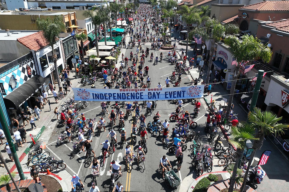 Thousands of cyclists and spectators fill a palm-lined downtown street during a festive Independence Day bike parade celebrating America's birthday along the Gulf Coast.