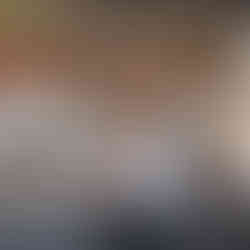 Open kitchen at Bistrology with chefs preparing dishes behind the counter, showcasing a modern, energetic dining atmosphere.