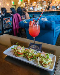 Fresh seafood tacos paired with a vibrant pink handcrafted cocktail inside Perch's relaxed yet upscale dining atmosphere.