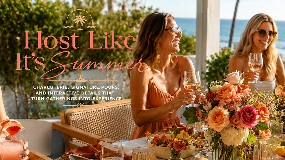 Coastal-inspired outdoor gathering featuring women enjoying drinks around a flower-filled table with ocean views, showcasing the warmth, connection, and effortless atmosphere of modern summer hosting.
